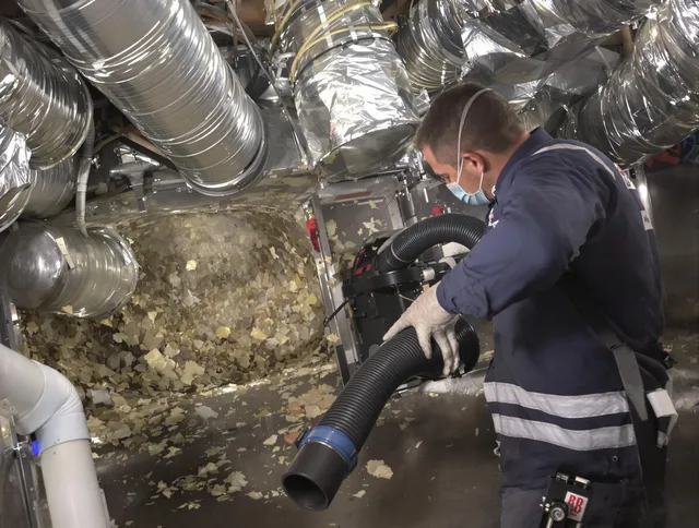 Somerset Air Duct Cleaning specialist operating negative pressure cleaning equipment for thorough duct maintenance in Somerset